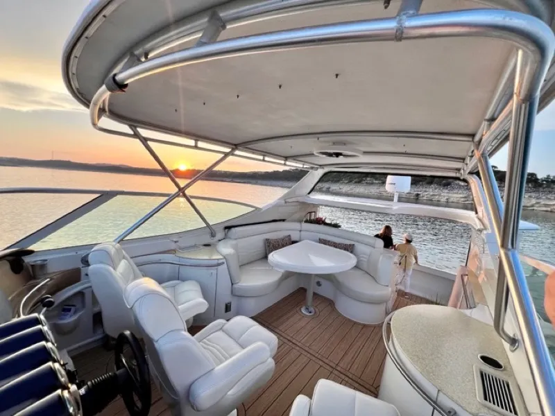 Private boat cruising on Lake Austin at sunset with the ATX Boats & Buses rental fleet
